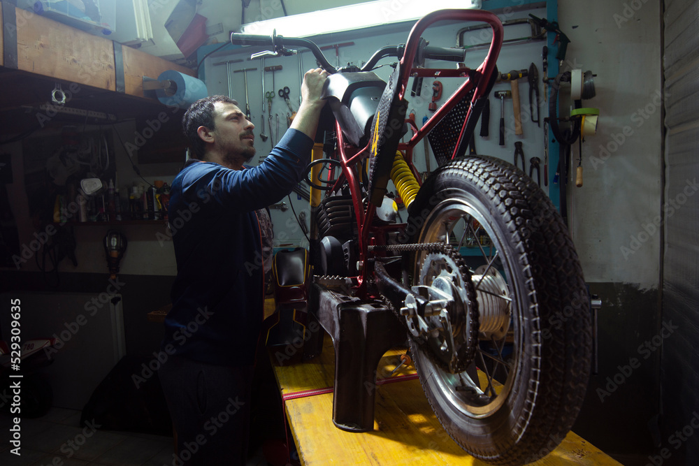 custom made wallpaper toronto digitalSide view of artisan repairing motorcycle at garage