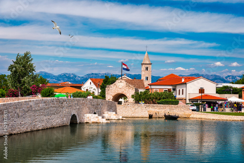 Fototapeta Naklejka Na Ścianę i Meble -  Historic town of Nin laguna view, Dalmatia region of Croatia. Street view of the famous Nin lagoon and medieval in Croatia. Colorful architecture in town of Nin, Dalmatia, Croatia