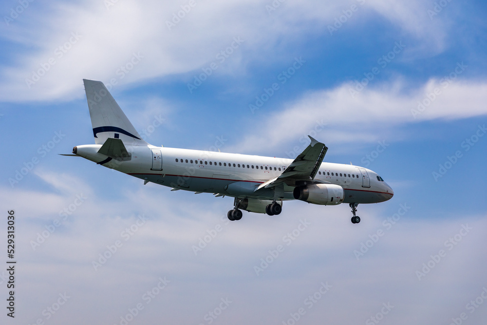 Landing airplane. Landscape with passenger airplane is flying in the blue sky with clouds. Passenger airliner. Business trip. Commercial aircraft. Passenger airplane flying and getting ready to land. Landing airplane. Landscape with passenger airplane is flying in the blue sky with clouds. Passenger airliner. Business trip. Commercial aircraft. Passenger airplane flying and getting ready to land.