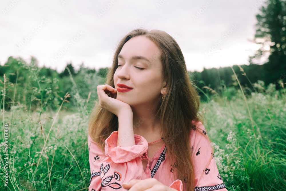 Young woman with eyes closed amidst plants in forest Young woman with eyes closed amidst plants in forest