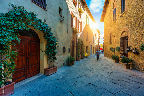 Cozy street decorated with colorful flowers, Pienza, Tuscany, Italy, Europe. Narrow street in the charming town of Pienza in Tuscany. Beautiful streets of the small and historic village Pienza, Italy © daliu