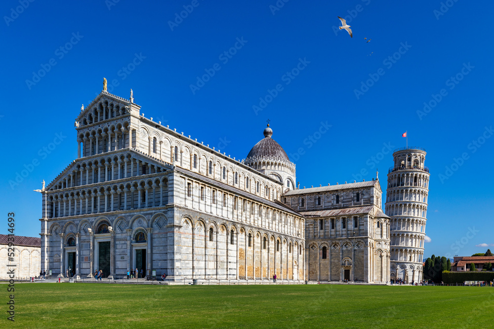 Pisa Cathedral and the Leaning Tower in a sunny day in Pisa, Italy. Pisa Cathedral with Leaning Tower of Pisa on Piazza dei Miracoli in Pisa, Tuscany, Italy.