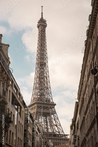 Low angle view of Eiffel Tower against cloudy sky in city photo