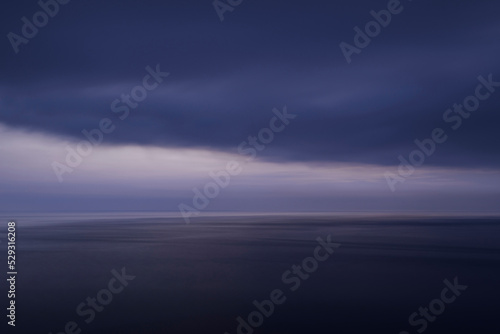 Scenic view of seascape against cloudscape at dusk photo