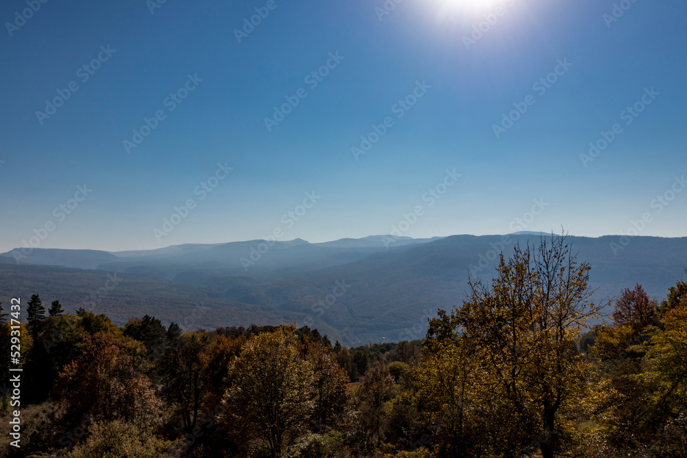 Scenic view of mountain ranges against clear blue sky during sunny day Scenic view of mountain ranges against clear blue sky during sunny day