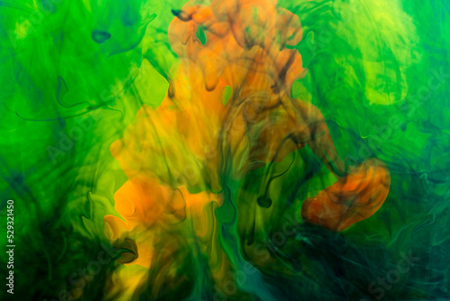 Ink in orange and marine colors dissolved in liquid