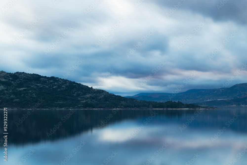 Beautiful reflections of clouds and mountains in the water of a lake Beautiful reflections of clouds and mountains in the water of a lake