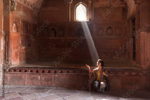 30 years old caucasian girl hit by a ray of sun inside Agra Fort India photo