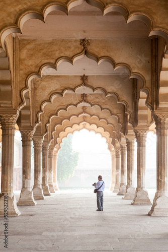 60 years old tourist with camera visiting Agra fort, India