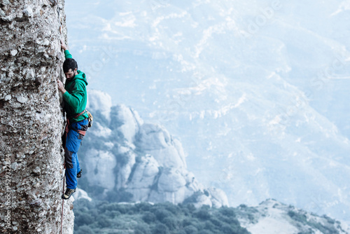 Climber sending a difficult route on sport climbing zone in Montserrat photo