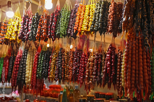 Bunches of different delicious churchkhelas at market photo