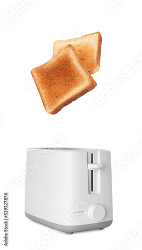 Roasted bread popping up of toaster on white background
