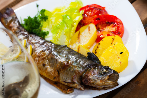 Whole roasted trout with grilled vegetables, lettuce salad and lemon