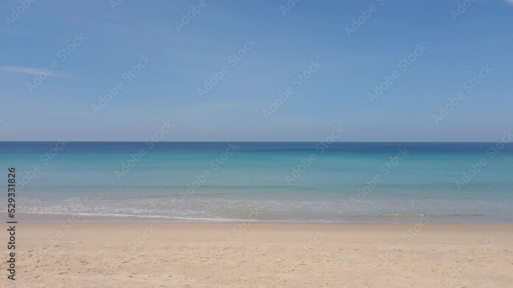 Beach sand blue ocean sea blue sky background video. Location Phuket beach sea, View of beach sea on sun light in the summer. At Karon Beach, Phuket, Thailand. 4K UHD, Video Clip ProRes 4:2:2 Beach sand blue ocean sea blue sky background video. Location Phuket beach sea, View of beach sea on sun light in the summer. At Karon Beach, Phuket, Thailand. 4K UHD, Video Clip ProRes 4:2:2
