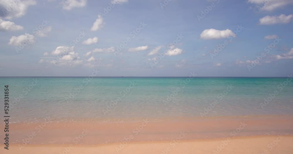 Beach sand blue ocean sea blue sky background video. Location Phuket beach sea, View of beach sea on sun light in the summer. At Karon Beach, Phuket, Thailand. 4K UHD, Video Clip ProRes 4:2:2 Beach sand blue ocean sea blue sky background video. Location Phuket beach sea, View of beach sea on sun light in the summer. At Karon Beach, Phuket, Thailand. 4K UHD, Video Clip ProRes 4:2:2