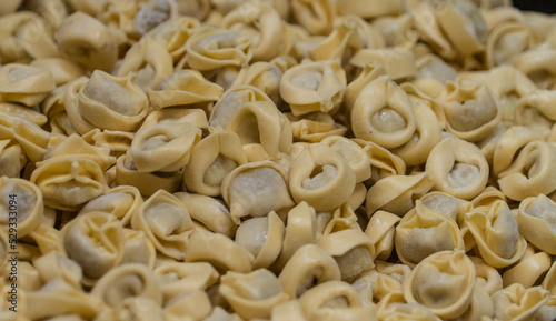 Close up view of ready to cook yellow color tortellini filled with meat at an Italian market