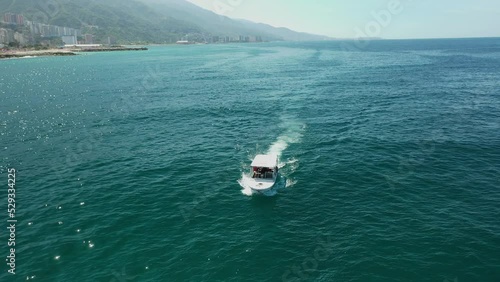 Aerial view of traditional fishing boat in Caraballeda with crystal clear turquoise sea, La Guaira, Venezuela. photo