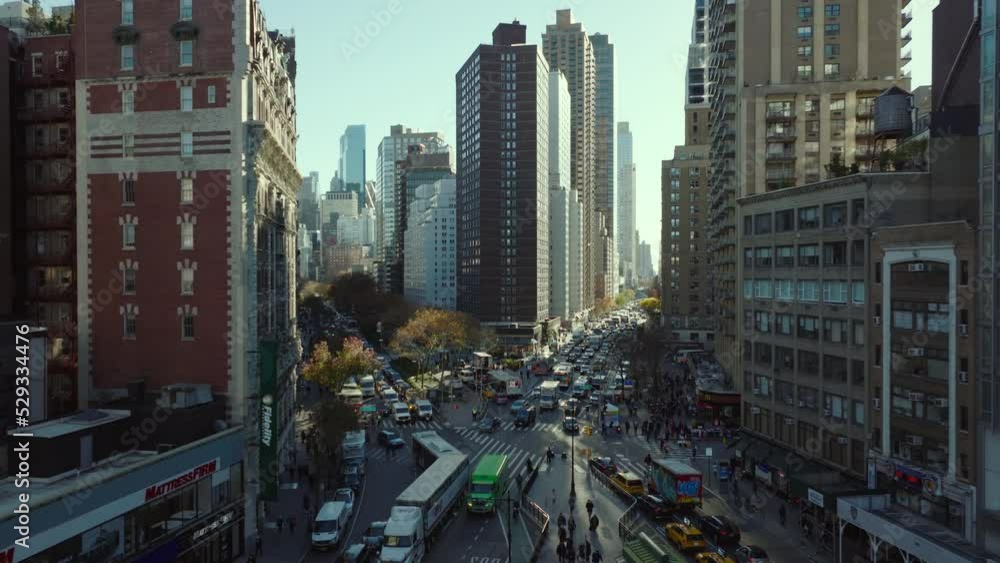 Traffic jam in streets of large city. Slowly moving or waiting vehicles in queue. Road intersection in rush hour. Manhattan, New York City, USA
