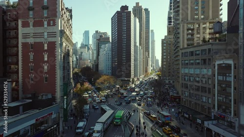 Traffic jam in streets of large city. Slowly moving or waiting vehicles in queue. Road intersection in rush hour. Manhattan, New York City, USA