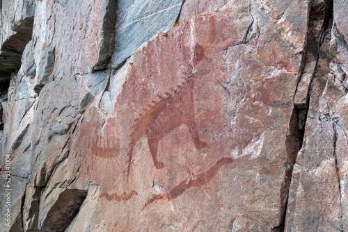 An ancient Indigenous pictograph is painted on a rock face on a cliff at the side of Lake Superior in the provincial park. photo