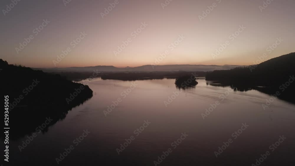 sunrise on the edge of the lake with hills in the background. dawn arrives with a purple sky. 4K videos. sunrise on the edge of the lake with hills in the background. dawn arrives with a purple sky. 4K videos.