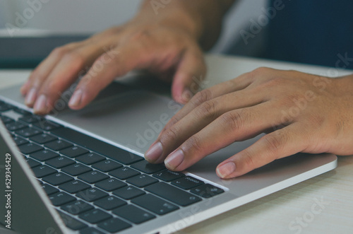 Laptop computer digital technology online. Businessman hand typing keyboard notebook at work communication internet at desk.