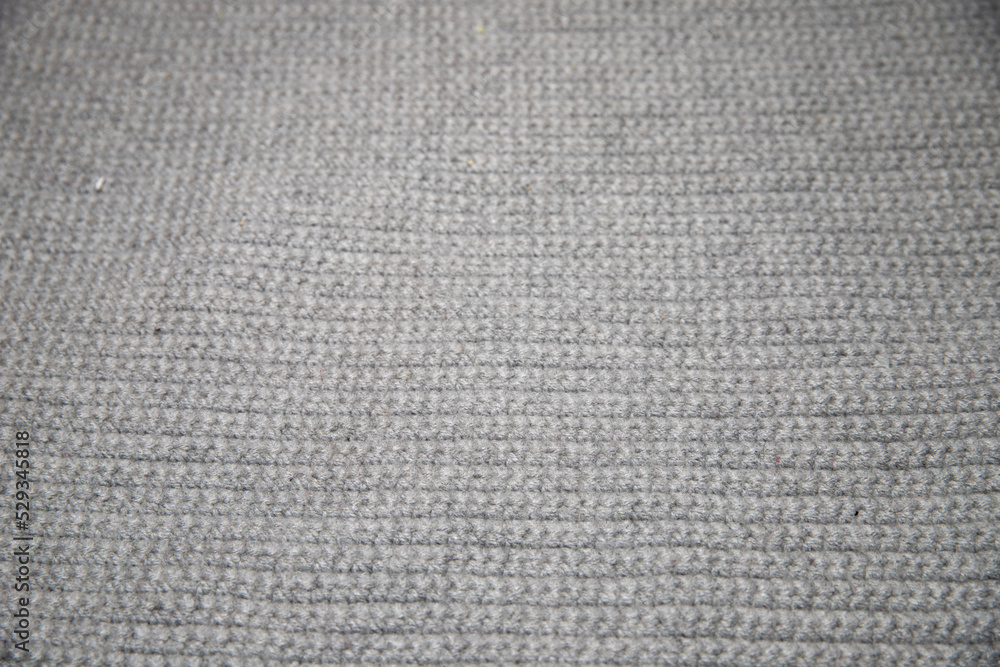 close up of gray knitted or crocheted tight knit blanket close up of gray knitted or crocheted tight knit blanket