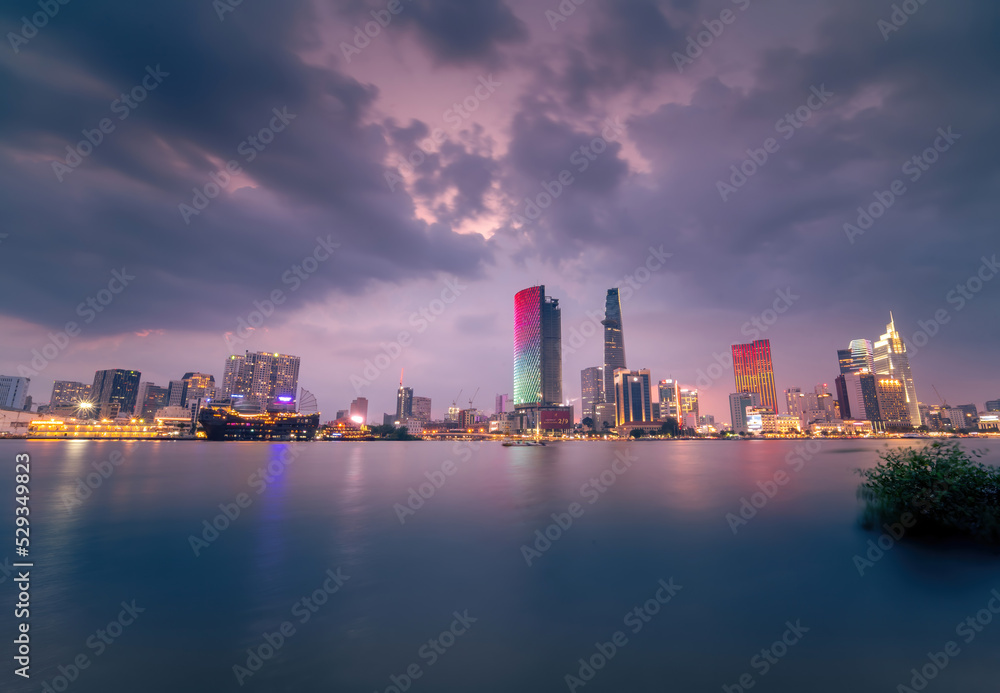 view of Bitexco and IFC One Tower, buildings, roads and Saigon river in Ho Chi Minh city - Laser and lighting show displayed. Travel and landscape concept.