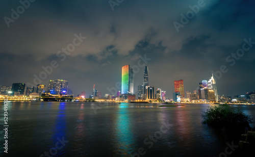 view of Bitexco and IFC One Tower  buildings  roads and Saigon river in Ho Chi Minh city - Laser and lighting show displayed. Travel and landscape concept.