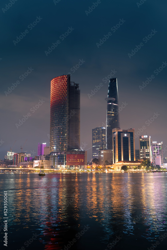 Obraz premium view of Bitexco and IFC One Tower, buildings, roads and Saigon river in Ho Chi Minh city - Laser and lighting show displayed. Travel and landscape concept.