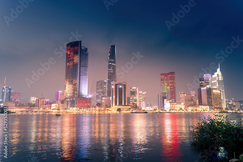 view of Bitexco and IFC One Tower, buildings, roads and Saigon river in Ho Chi Minh city - Laser and lighting show displayed. Travel and landscape concept.