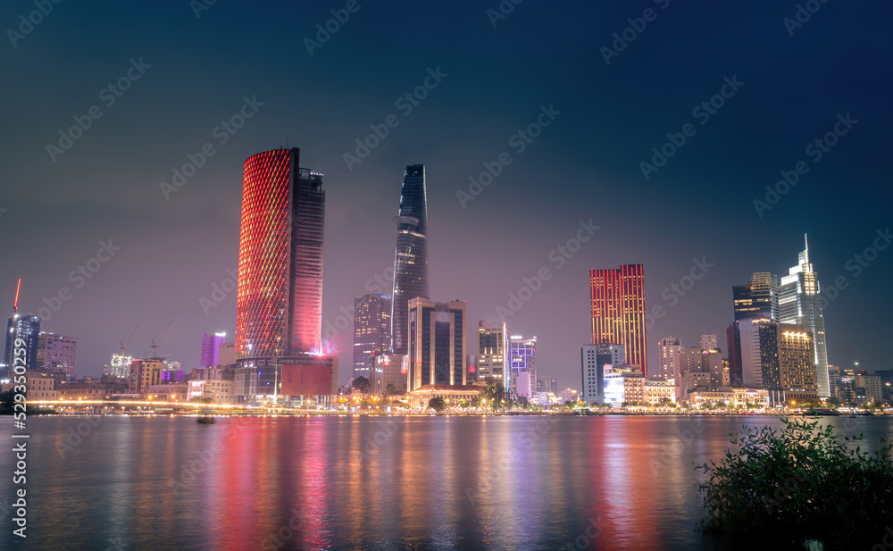 Beautiful view of Ho Chi Minh City skyline and the Saigon River at sunset. Amazing colorful view of skyscraper and other modern buildings at downtown