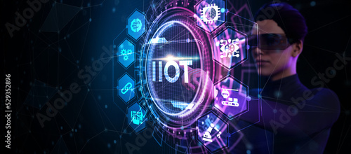 Internet of things - IOT concept. Businessman offer IIOT products and solutions. The future of technology. Virtual screen of the future with the inscription: IIOT.