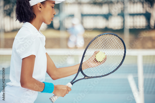 Tennis, racket and serve with woman athlete training on game court for fitness, workout and health. Motivation, competition and match with young female playing sports exercise for active lifestyle © David L/peopleimages.com