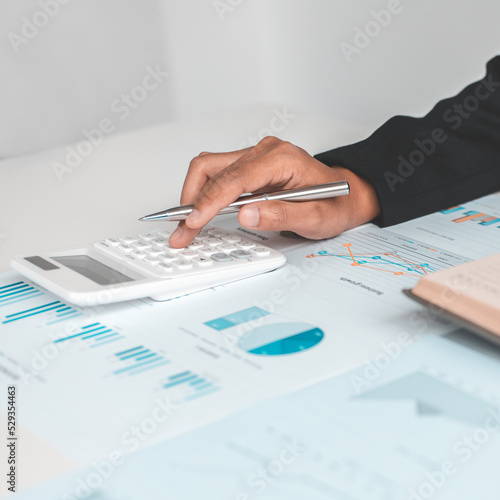 Accounting businessmen are calculating income-expenditure and analyzing real estate investment data, Dedicated to the progress and growth of the company, Financial and tax systems concept.