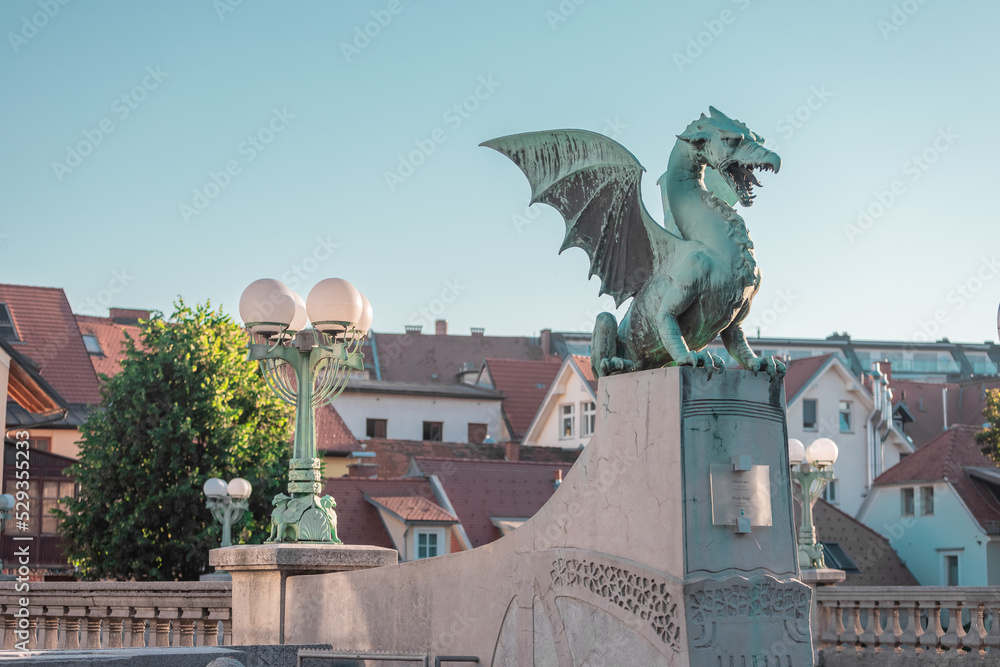 Famous dragon bridge or zmajski most, a landmark in ljublana, slovenia in early morning hours. Nobody around. Detail of dragon and piedestal.