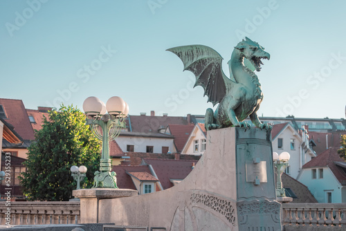 Famous dragon bridge or zmajski most, a landmark in ljublana, slovenia in early morning hours. Nobody around. Detail of dragon and piedestal. photo