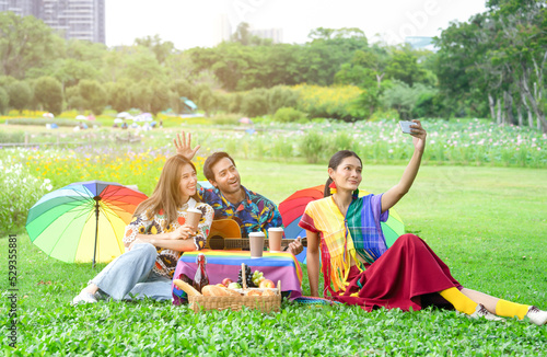 group of lgbt friends meeting and having a picnic on vacation,young asian lgbtq in colorful lgbtq symbol dresses doing selfie joyfully in the park, concept of lgbtq lifestyle,life,lgbtq community
