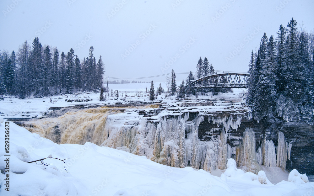 View on the frozen waterfall of Chute-Aux-Galets on a snowy winter day near Saguenay, Quebec (Canada)