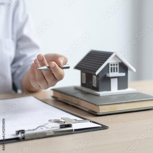 Real estate agent or sales manager has offered home sales and explained the terms of signing the house purchase contract and free home insurance, Finance and after-sales service concept.