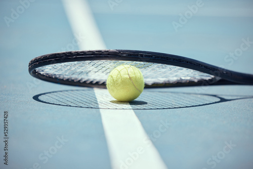 Tennis court ball, badminton bat and sports ground with racket silhouette, shadow and sunshine on training floor. Outdoor sun background turf for game, playing match and healthy fitness hobby skill © David L/peopleimages.com