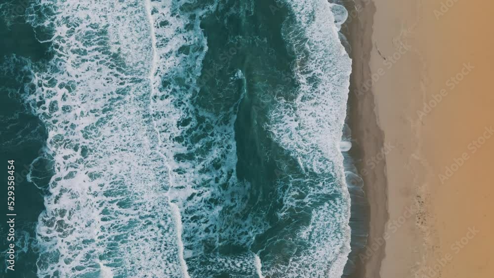 Golden sand waves and turquoise sea water with white foam from small waves Scenic aerial view. Concept of summer holidays. Bright abstract background perfect for any design. Drone slide up Golden sand waves and turquoise sea water with white foam from small waves Scenic aerial view. Concept of summer holidays. Bright abstract background perfect for any design. Drone slide up