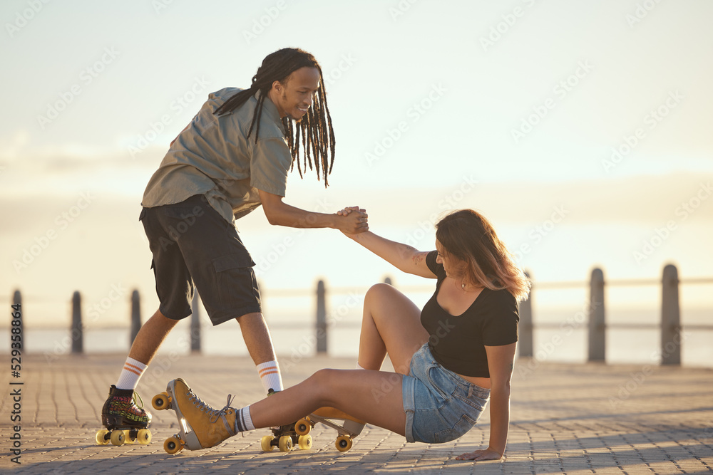 Help, falling and couple roller skating and holding hands at the beach in  summer for a