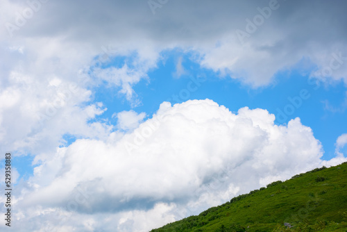 cumulus clouds above the hill. weather forecast in mountains. summer nature scenery © Pellinni