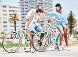 Black man, kiss woman hand and outdoor park holiday in miami. Couple on romantic summer date, cycling in city street and happy girlfriend. Young boyfriend in love, leisure bike ride and sunshine