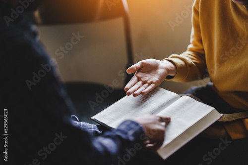 Obraz na płótnie Christian couple or group reading study the bible together and pray at a home or Sunday school at church