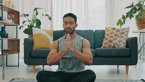 Meditation exercise, man yoga training and zen workout for spiritual health, relax for wellness and prayer hands for health in living room. Calm, healthy and Asian person praying for motivation