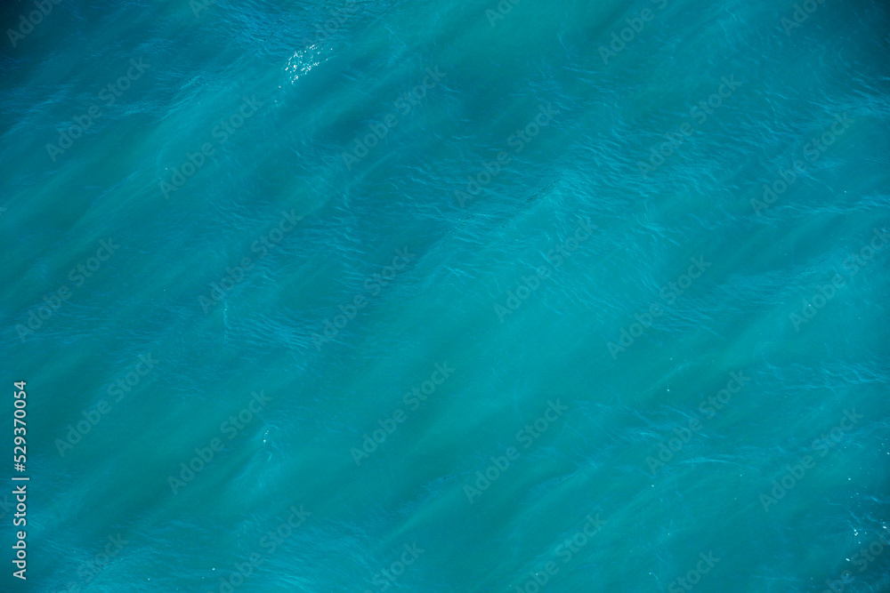 Sea water texture. Sunlight ray in surface of water. Abstract art background. Scenic natural design in water waves. Wallpaper for desktop. Sea water texture. Sunlight ray in surface of water. Abstract art background. Scenic natural design in water waves. Wallpaper for desktop.