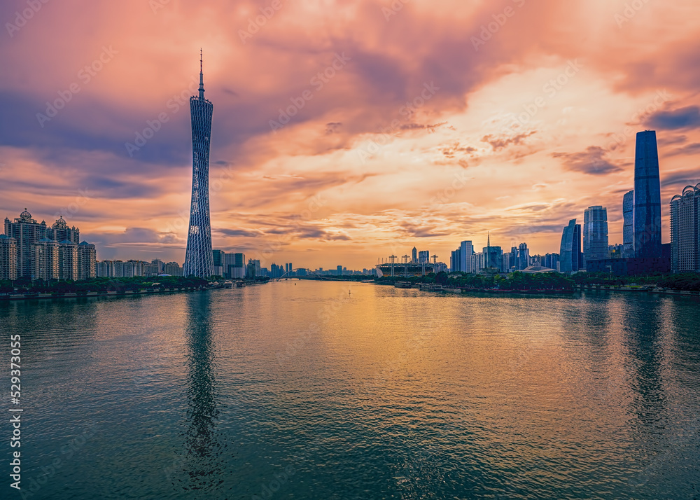 Guangzhou, Guangdong, China. Pearl (Zhujiand) River, city skyline at sunset. 