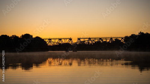 two bridges in sunrise above river